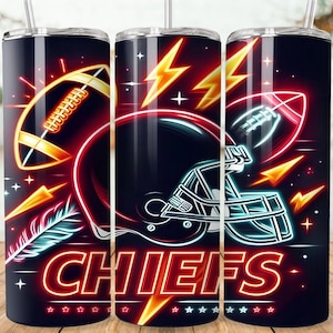 May include: Three black insulated tumblers with a Chiefs football theme. Each tumbler features a football, helmet, and lightning bolts in red, yellow, and white neon designs. The word "CHIEFS" is displayed in red neon.