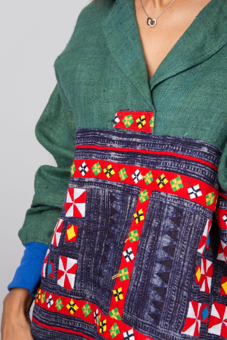 K&ouml;nnte beinhalten: Ein lang&auml;rmeliges Hemd in Gr&uuml;n und Blau mit einem bunten geometrischen Muster. Das Hemd hat einen Kragen und einen Knopfverschluss.