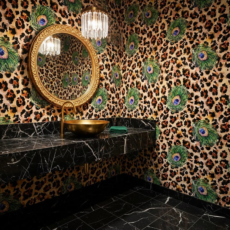 May include: A luxurious bathroom with a black marble countertop and floor. A gold-colored sink and faucet are set against a wall with a leopard print and peacock feather design. A round gold mirror and a crystal chandelier complete the look.