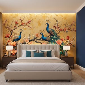 May include: A bedroom featuring a bed with a beige headboard and bedding. The wall behind the bed has a gold-toned mural with peacock and floral designs. Two matching nightstands with lamps flank the bed. A large mirror is on the right wall.