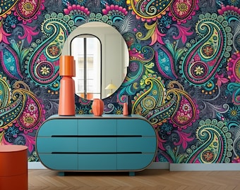 May include: A vibrant interior scene featuring a teal dresser with orange decor and a round mirror. The backdrop is a colorful paisley wallpaper in shades of teal, pink, yellow, and blue. Two orange stools are in the foreground.
