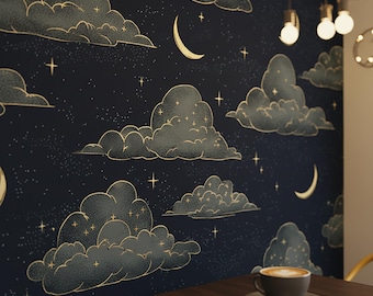 May include: Dark blue wallpaper featuring a celestial design with gold-outlined clouds, crescent moons, and stars. The repeating pattern creates a dreamy, night sky aesthetic. A cup of coffee sits on a dark brown table.