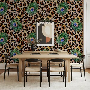 May include: A dining room featuring a light wood table and black chairs. The wallpaper has a leopard print pattern with peacock feather accents. A framed abstract art piece hangs on the wall, and a chandelier is above the table.