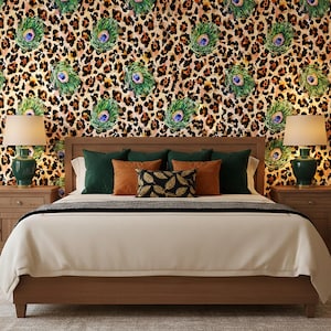 May include: A bedroom with a wooden bed frame, a cream-colored comforter, and decorative pillows. The pillows are in shades of green, orange, and black. The wallpaper features a leopard print with peacock feather accents. Two green lamps sit on nightstands.