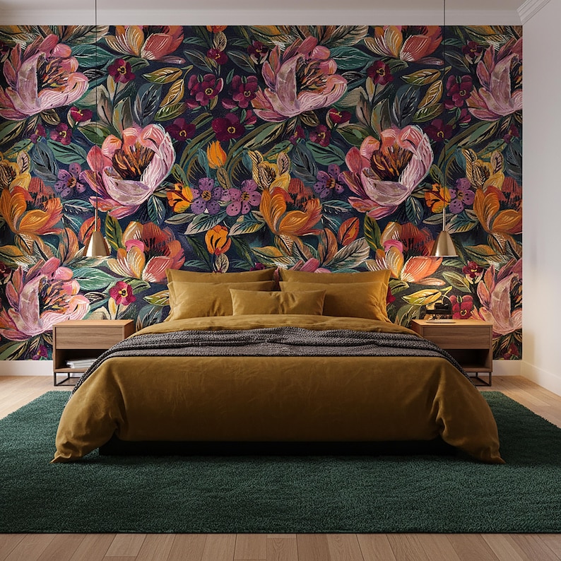 May include: A bedroom with a floral wallpaper featuring large pink, orange, and purple flowers on a dark background. The bed has mustard-coloured bedding and a dark green rug.