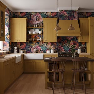 May include: A kitchen with mustard-yellow cabinets, a dark wood island, and floral wallpaper. The kitchen has a farmhouse sink, a range, and two pendant lights. Two wooden chairs are at the island.