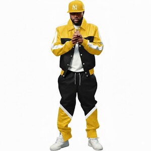 May include: A yellow, black, and white track suit with a matching baseball cap. The jacket is yellow with black and white accents. The pants are black with yellow and white details. The cap is yellow with a white logo.