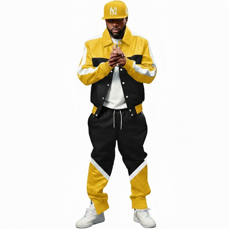 May include: A yellow, black, and white track suit with a matching baseball cap. The jacket is yellow with black and white accents. The pants are black with yellow and white details. The cap is yellow with a white logo.