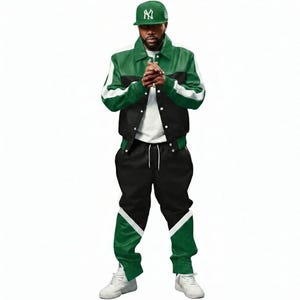 May include: A green and black jacket with white accents, paired with matching black sweatpants featuring green and white details. The outfit is completed with a green baseball cap with a white logo and white sneakers. The ensemble is a stylish streetwear look.