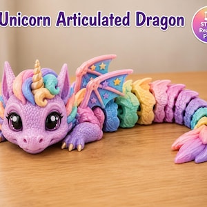 May include: An articulated dragon figurine with a unicorn horn, featuring a pastel colour palette of purple, pink, blue, and yellow. The dragon has large eyes, textured scales, and wings decorated with small stars. Text reads: Unicorn Articulated Dragon.