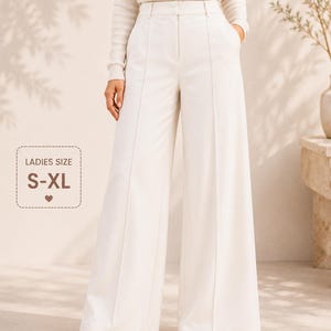 May include: Off-white high-waisted wide-leg trousers featuring a structured waistband, a centre front zip closure, and vertical seam detailing down the front of each leg. The text LearnSewingHub and LADIES SIZE S-XL are visible.