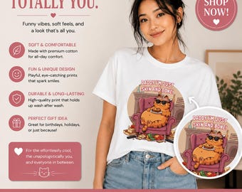 May include: White t-shirt featuring a cartoon cat in sunglasses with the text "DADDY I'M JUST SKIN AND BONE!". Made from premium cotton, the shirt is machine washable. The image also includes the text "COMFY. FUNNY. TOTALLY YOU."
