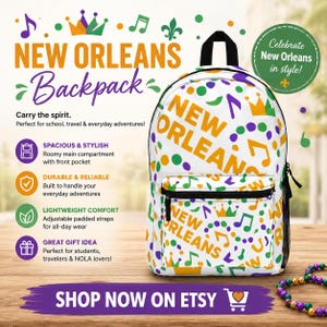 Puede incluir: Mochila blanca con temática de Nueva Orleans, con notas musicales, coronas y las palabras "New Orleans" en naranja y morado. Incluye un bolsillo frontal y correas ajustables. También se ve el texto "Shop Now on Etsy".
