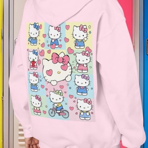 6 7 Hello Kitty Collage Youth Hoodie | Kids 6 7 Graffiti Style Font In Front And Hello Kitty Graphic Design On Back | Hello Kitty Six Seven image 1