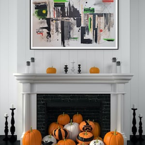May include: A living room decorated for Halloween. A large abstract painting hangs above a white fireplace mantel. The mantel is decorated with orange pumpkins, black candlesticks, and candles. A variety of pumpkins are arranged in front of the fireplace.