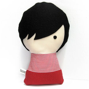 Custom made dolls resembling your beloved ones. The picture shows a sample of a woman with black hair with bangs, stripped red shirt and red skirt. You can order your doll and chose among many options. Made out of cotton and wool felt.