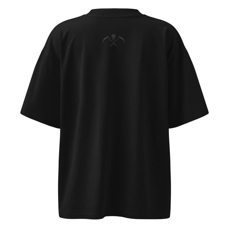 Back view black unisex shirt with small logo under collar minimalist gothic apparel detail