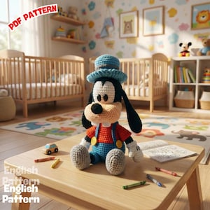 May include: A crocheted Goofy doll wearing a blue hat, red shirt, and blue overalls, sitting on a wooden table. The doll has black ears and a large, tan snout. The words "PDF PATTERN" and "English Pattern" are visible in the image.