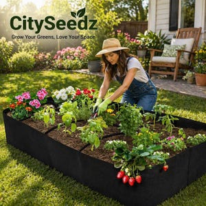 May include: A black raised garden bed filled with soil and various plants, including flowers and strawberries. A person wearing a hat and gloves tends to the plants. The text "CitySeedz" and "Grow Your Greens, Love Your Space" is visible.