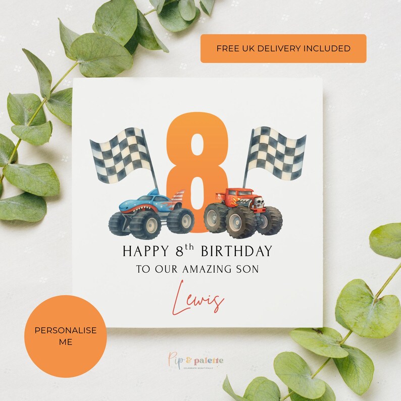 May include: A white birthday card with an orange number 8 and two monster trucks. The card reads "HAPPY 8th BIRTHDAY TO OUR AMAZING SON" with the name "Lewis" in cursive. Checkered flags are on either side of the number 8.