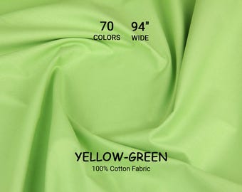May include: Yellow-green 100% cotton fabric, 94 inches wide, available in 70 colors. The fabric is a bright, solid color with a smooth texture. The text "YELLOW-GREEN" and "100% Cotton Fabric" are displayed on the fabric.