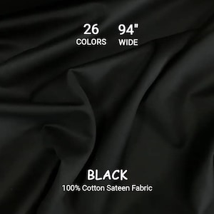 Könnte beinhalten: Schwarzer 100% Baumwoll-Satin-Stoff, 239 cm breit. Das Bild zeigt den Stoff drapiert, mit sichtbaren Falten und Schatten. Text zeigt 26 Farben an. Das Wort "BLACK" ist prominent dargestellt.