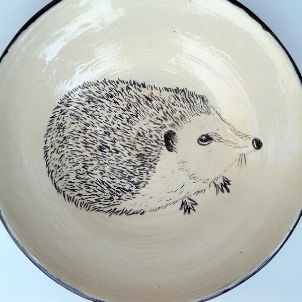 Wheel thrown shallow bowl / plate / dish with sgraffito'd hedgehog using white slip on dark chocolate stoneware