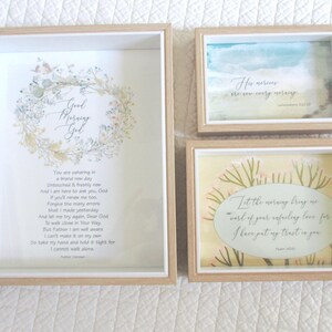 May include: Three framed prints with inspirational quotes and floral designs. The first print features a wreath of flowers and the text "Good Morning God". The second print features a blue watercolour background and the text "His mercies are new every morning". The third print features a yellow watercolour background and the text "Let the morning bring us word of your unfailing love, for I have put my trust in you."