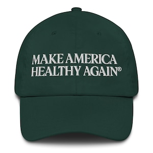 May include: A dark green baseball cap with the embroidered text "MAKE AMERICA HEALTHY AGAIN" in white. The cap has a curved brim and a rounded crown, typical of a classic baseball hat.