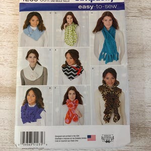 May include: Simplicity sewing pattern 1235 OS, featuring various scarf designs. The package includes images of different scarf styles, including a blue denim-like scarf, a green polka dot scarf, and a fringed teal scarf. The text "easy-to-sew" is visible.