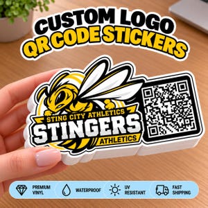 May include: A stack of custom die-cut stickers featuring a yellow and black hornet mascot graphic, the text STING CITY ATHLETICS STINGERS ATHLETICS, and a black and white QR code. The stickers are white with bold black and yellow outlines.
