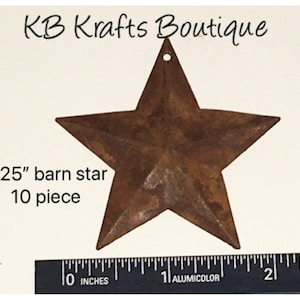 May include: A rustic, brown metal barn star with a distressed finish. The star is 2.25 inches in size and has a small hole at the top for hanging. The text "KB Krafts Boutique" is at the top. The text "2.25" barn star 10 piece" is on the left.