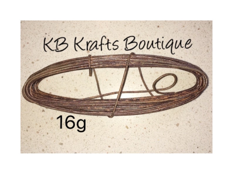 May include: A coil of brown 16 gauge wire.  The wire is wrapped around itself in a circular shape.  The text "KB Krafts Boutique" is visible in the top right corner of the image.