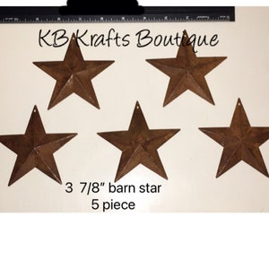 May include: Five rustic brown metal barn stars, each measuring 3 7/8 inches. The stars are arranged in a semi-circle on a white background. The text "KB Krafts Boutique" and "3 7/8" barn star 5 piece" is visible below the stars.
