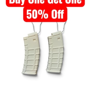 May include: Two off-white, curved rifle magazines with a textured grid pattern on the exterior, each suspended by a silver metal hook. Above the magazines, a red rectangular banner displays the white text: Buy One Get One 50% Off.