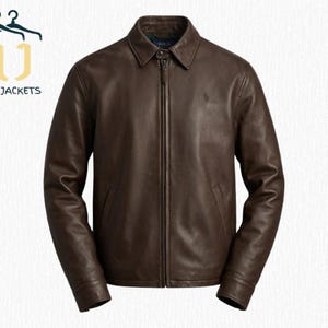May include: A brown leather jacket with a full zipper closure and a collared neckline. The jacket has a small logo on the chest and is from Noir Jackets.