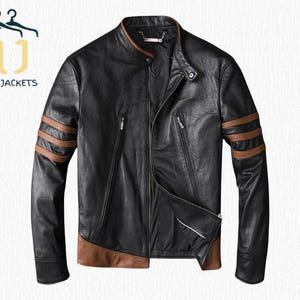 May include: Black leather jacket with brown detailing on the shoulders and hem. It has a zip closure and a stand-up collar. The text "NOIR JACKETS" is visible.