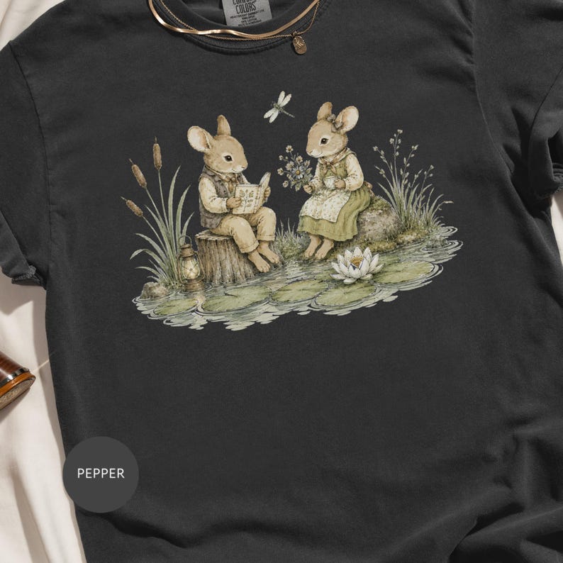 Two mice sit by a pond; one reads a book, the other holds flowers and tea.