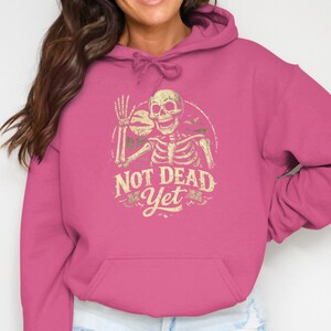 Not Dead Yet Skeleton Design, Funny Halloween Shirt, Spooky Vintage Skeleton, Humorous Zombie Bats Moon Art, Creepy Gift Idea.
Not Dead Yet