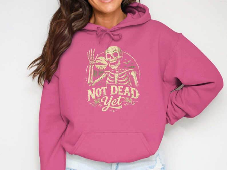 Not Dead Yet Skeleton Design, Funny Halloween Shirt, Spooky Vintage Skeleton, Humorous Zombie Bats Moon Art, Creepy Gift Idea.
Not Dead Yet