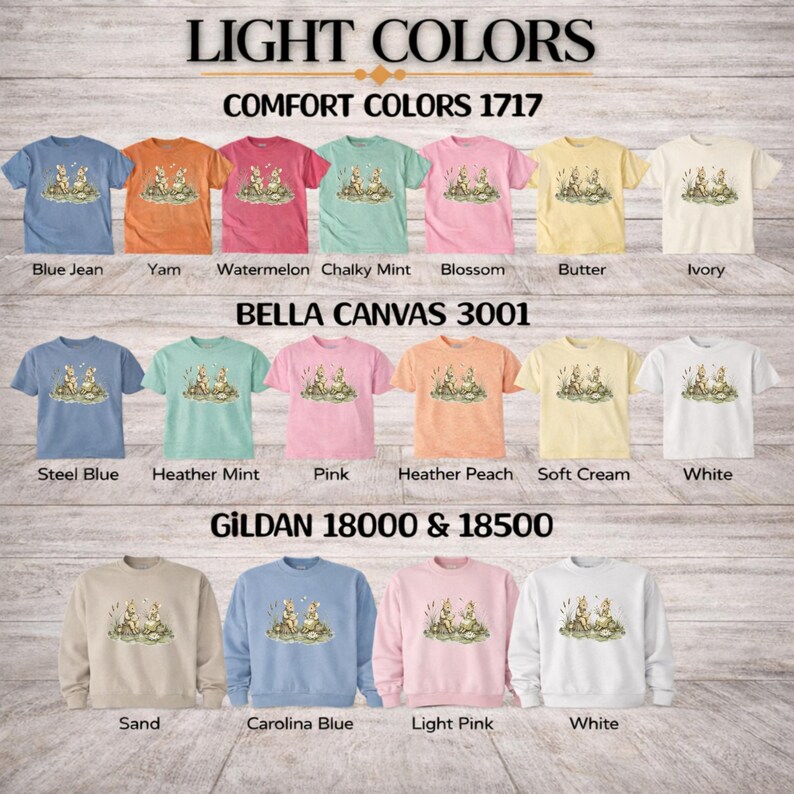 T-shirts and sweatshirts in various light colors featuring a graphic of two bunnies by water lilies.