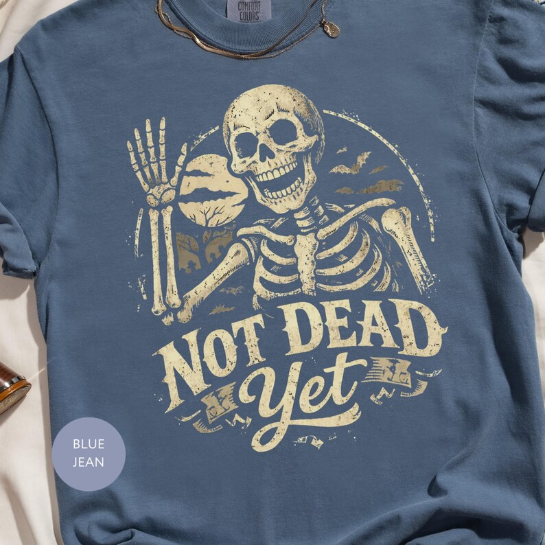 Not Dead Yet Skeleton Shirt, Funny Halloween Skeleton Tee, Spooky Goth Skull Graphic T-Shirt, Sarcastic Grim Reaper Gift
Not Dead Yet Shirt