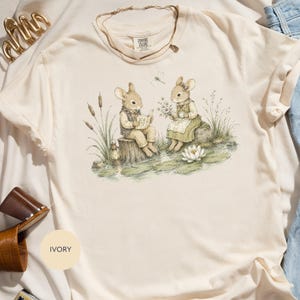 Ivory Comfort Colors t-shirt with rabbit illustration on lakeside.