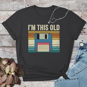 Camiseta de disquete. Camiseta retro de ordenador: diseño tecnológico vintage, icono clásico de almacenamiento de datos. Camiseta geek humorística, nostalgia.