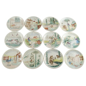 Rare Antique French Benjamin Rabier for Sarreguemines Gilt Rimmed Polychrome Earthenware &quot;Talking Plates&quot;, Complete Set 1-12