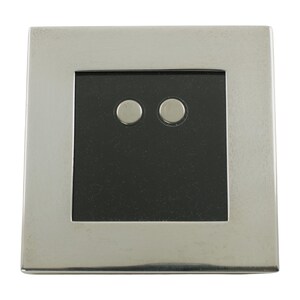 May include: A square, silver-toned light switch plate with a black center. Two small, circular buttons are centered on the black square. The plate has a brushed metal finish and a simple, modern design.