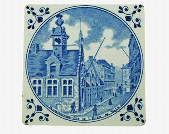 Antique Delft Trivet Tile Titled 'Blankenberghe - Rue de L'Hotel de Ville' with Ochsenkopf Corner Motifs