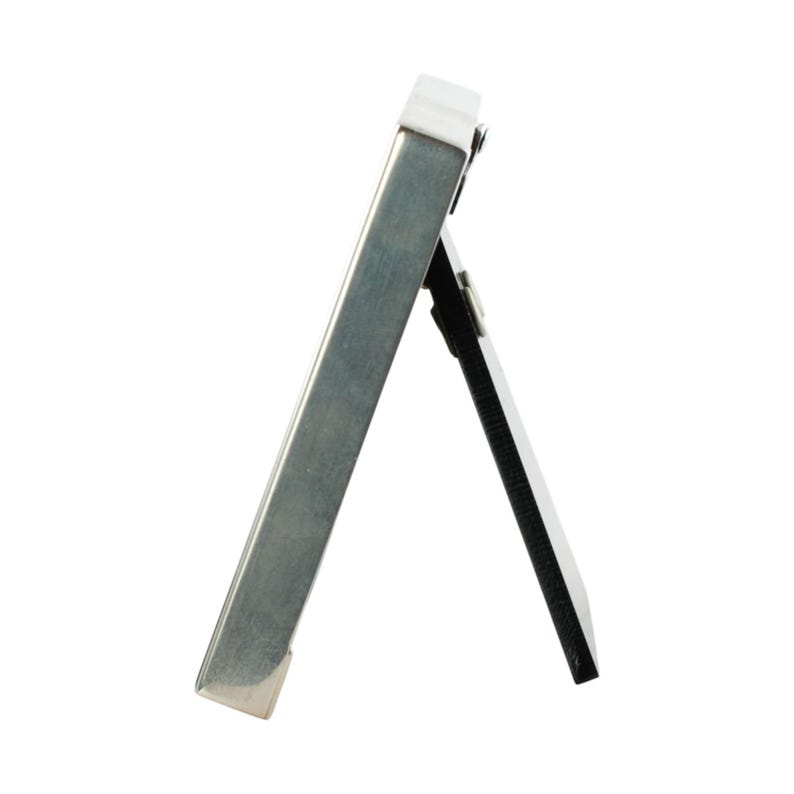 May include: A small, silver-colored picture frame with a hinged easel back. The frame is rectangular and has a simple, modern design. The back of the frame is black.