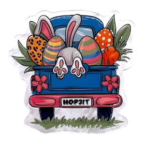 May include: A blue truck bed illustration filled with Easter eggs, carrots, and greenery. A bunny's rear and paws are visible. The truck bed has pink flowers and the text "HOP2IT".