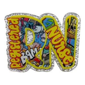 May include: A Registered Nurse badge with a silver glitter border. The letters "RN Nurse" are in yellow with a colorful graffiti-style design inside. The word "Registered" is vertically aligned.